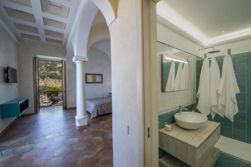 y baño con lavabo y espejo. en AMORE RENTALS - Casa Volte Alte, en Positano