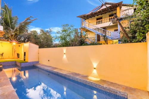a swimming pool in front of a building at FabExpress Victoria With Pool, Baga Beach in Baga