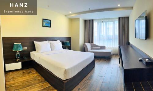 a hotel room with a bed and a chair at HANZ Premium Mai Vy Hotel in Tây Ninh