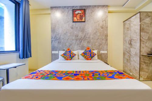 a bedroom with a large bed in a room at FabHotel Gargi Inn in Pune