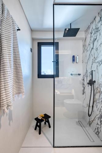 a bathroom with a glass shower stall and a toilet at Neoma in Athens