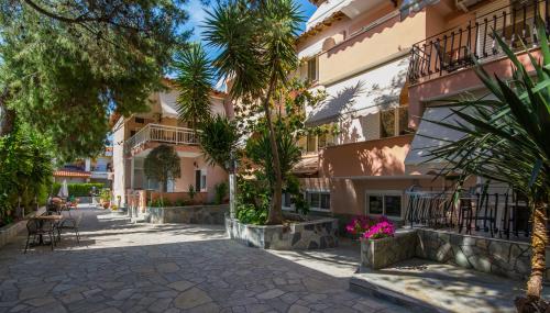 a street in a town with palm trees and buildings at Jolandas House in Toroni