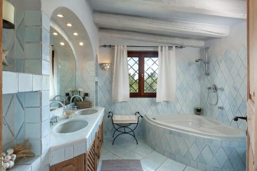 baño con bañera grande y lavamanos en Villa Hortensia en Arzachena