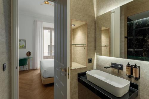a bathroom with a sink and a mirror at Be Mate Málaga Centro in Málaga