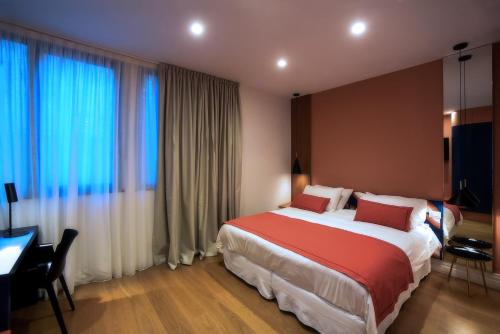 a hotel room with a large bed and a desk at Magnolia Napoli in Naples