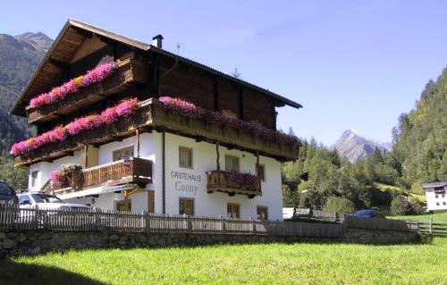 a building with flowers on the side of it at Gästehaus Conny in Prägraten