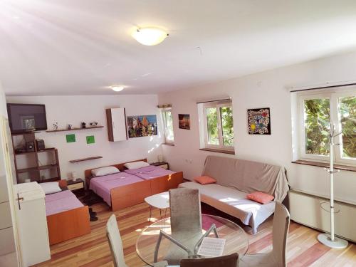 a living room with a couch and a table at Green house in Čavle