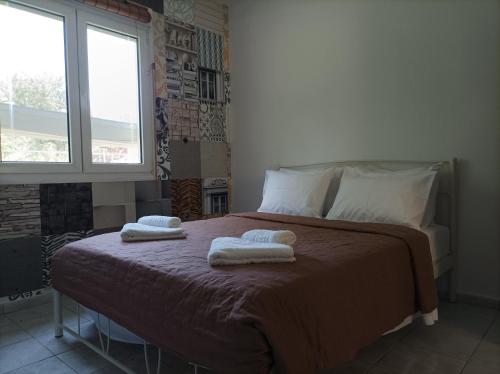 a bedroom with a bed with two towels on it at thassossweethome in Limenas
