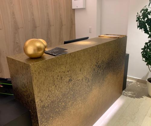 a reception desk with a golden apple on top of it at Hotel Alpina in Kleinarl