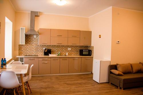 a kitchen with a couch and a table in a room at Villa Pirken Hammer in Pirkenhammer