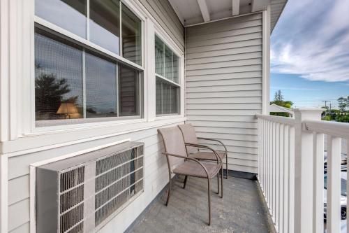 a chair sitting on the balcony of a house at Seasider Motel in Bar Harbor