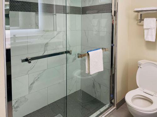 a bathroom with a glass shower with a toilet at Quality Inn & Suites Lake Charles in Lake Charles