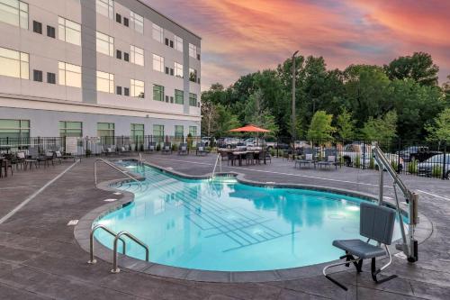 a large swimming pool in front of a building at Cambria Hotel Nashville Airport in Nashville