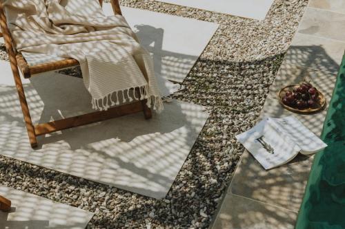 a blanket on a chair on a mosaic floor at BATU Luxury Apartments in Preveza