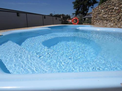 a large pool of blue water in a backyard at Casa da Roda - Turismo de Habitação in Pinhel