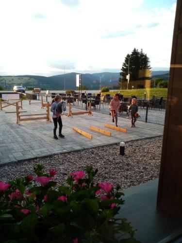 a group of children playing in a park at Apartmány Family aréna in Benecko
