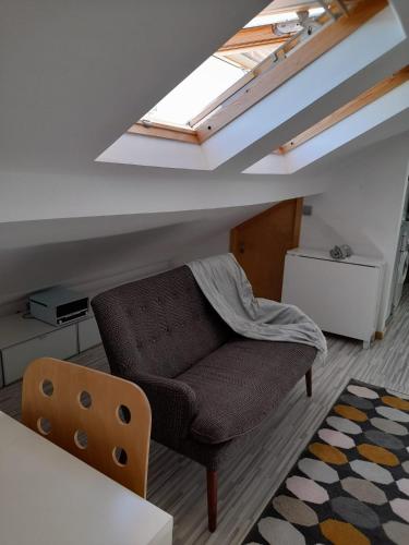 a living room with a couch and a skylight at Bemar Loft in Costa da Caparica
