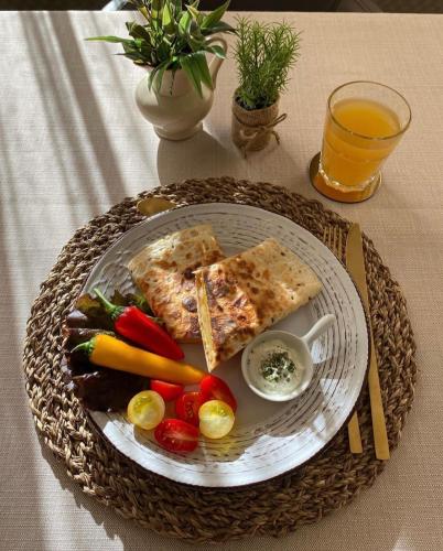 a plate of food with bread and vegetables on a table at Hotel Banja Luka in Banja Luka