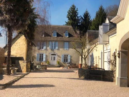 a large stone building with a palm tree in front of it at Les Perséides in Lézignan