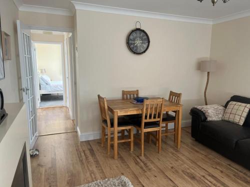 a dining room with a table and chairs and a couch at Castle View Dover in Dover