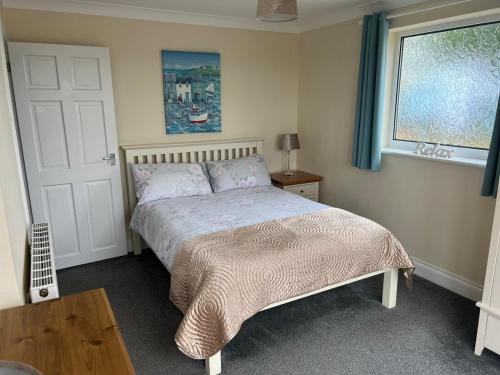 a bedroom with a bed and a table and a window at Castle View Dover in Dover