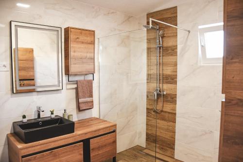 a bathroom with a sink and a shower at Apartments Olea in Biograd na Moru