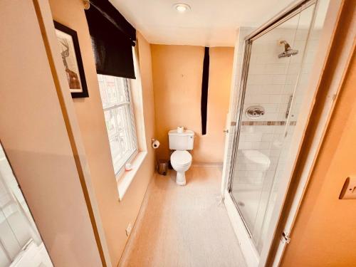 a bathroom with a toilet and a walk in shower at George & Dragon Hotel in Buckinghamshire