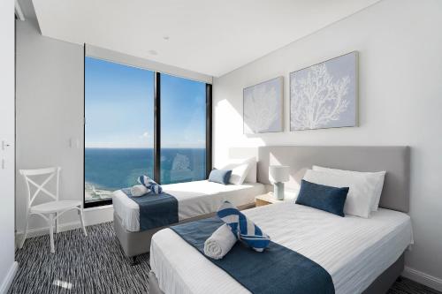 a hotel room with two beds and a large window at Sea view Beachfront apartment in surfers in Gold Coast