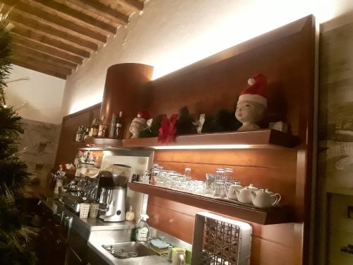 a kitchen with a elf on the shelf above a sink at Hotel Due Colonne in San Bonifacio