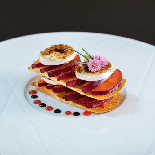 a stack of pancakes with a flower on a plate at Vila Valverde Design Country Hotel in Luz