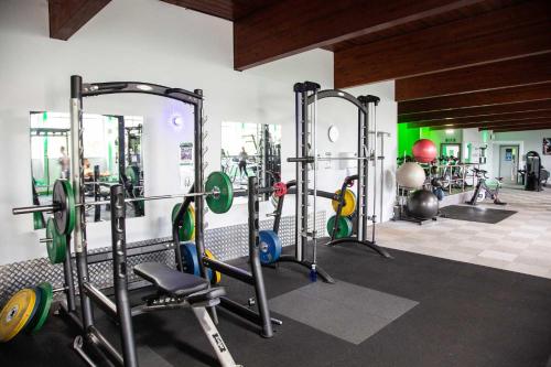 a gym with several tread machines in a room at Glenville House - Adults Only - Incl FREE off-site health club with swimming pool, hot tub, sauna & steam room in Windermere