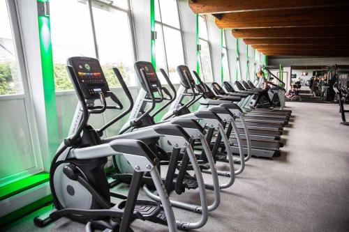 a row of exercise bikes in a gym at Glenville House - Adults Only - Incl FREE off-site health club with swimming pool, hot tub, sauna & steam room in Windermere