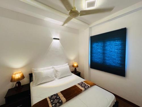 a bedroom with a bed and a large window at Dream Stay Green in Nuwara Eliya