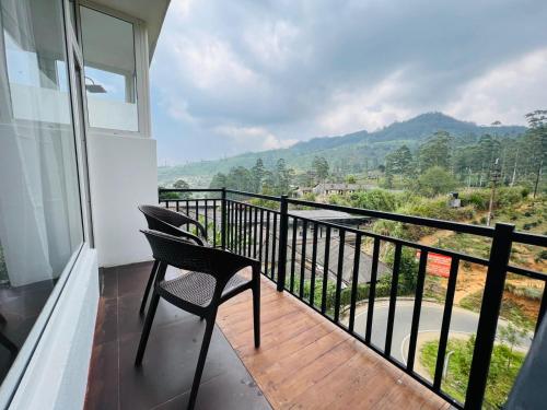 a balcony with a chair and a view of a mountain at Dream Stay Green in Nuwara Eliya