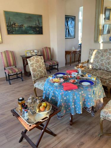 a living room with a table with food on it at Palac Osowo gostynskie in Gostyń