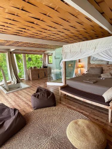 a large bedroom with two beds and a wooden ceiling at Samura Maldives Guest House Thulusdhoo in Thulusdhoo