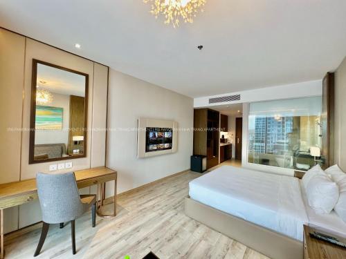 a hotel room with a bed and a desk and a desk at Panorama Nha Trang Inn in Nha Trang