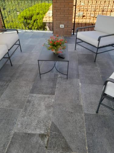 a patio with two chairs and a table on a patio at Agriturismo La Terrazza in Velva