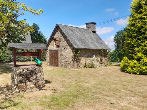 an old stone house with a bench in front of it at La Jolie Petite Maison for groups 1-5 in Fontenermont