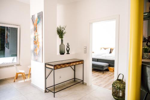 a living room with a table with a vase on it at Landhaus dasThomas in Henndorf 