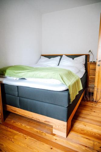 a bed in a bedroom with a blue bed frame at Landhaus dasThomas in Henndorf 