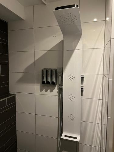 a shower in a bathroom with white tiled walls at City Center Studio Amsterdam in Amsterdam
