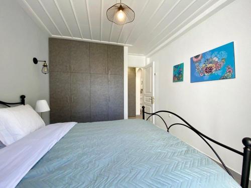 a bedroom with a bed with a large headboard at Pine Trees and Sea View Houses in Hydra - Daphne, Chloe, Myrto, Eleni in Hydra