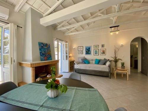 a living room with a table and a couch at Pine Trees and Sea View Houses in Hydra - Daphne, Chloe, Myrto, Eleni in Hydra