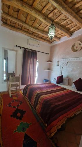 a bedroom with a large bed in a room at Auberge Tissadrine in Akhendachou nʼAït Ouffi