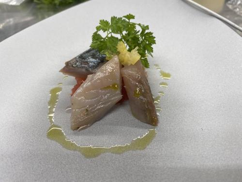 a white plate with a piece of food on it at Locanda degli Artisti Art Hotel in Canazei