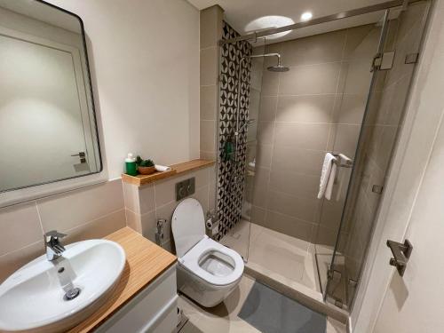 a bathroom with a sink and a toilet and a shower at Dubai Hills Estate Deluxe 2 bedroom Apartment Collective Tower A 603 in Dubai