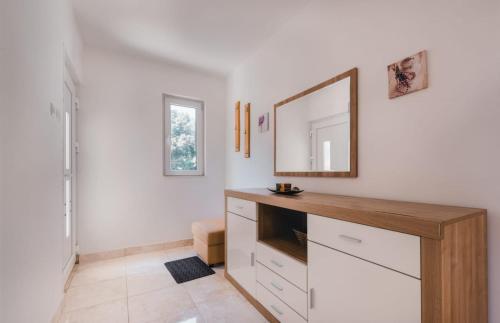 a white room with a mirror and a dresser at Apartman Luka in Molat