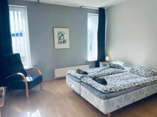 a bedroom with a bed and a blue wall at Tallinn Seaside Apartment in Tallinn