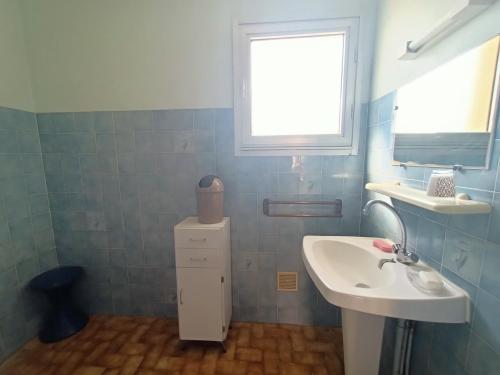 łazienka z białą umywalką i oknem w obiekcie Appartement pour 4 personnes à 50m de la plage Narbonne Plage 4LP2A8 w mieście Narbonne-Plage